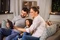 Happy family with tablet computer at home at night Royalty Free Stock Photo