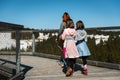 Family people walking wooden treetop observation deck walkway in winter