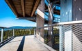 Family people walking wooden treetop observation deck walkway in winter