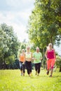 Family with personal Fitness Trainer jogging Royalty Free Stock Photo