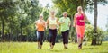 Family with personal Fitness Trainer jogging Royalty Free Stock Photo