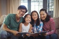 Family with photo album together in living room Royalty Free Stock Photo