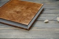 Family photo book with embossing. Photo book on a wooden background. Brown photo book with wood cover. Photoalbum with a hard Royalty Free Stock Photo