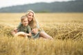 Family photo: mom blonde with long hair and son playing in the field. The family in the village. Family value