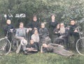 Family photo painted, family and nine children posing in the background of the garden with two bicycles xylophone