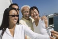 Family photographing themselves on sailboat Royalty Free Stock Photo