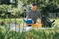 Family picnic. Dad and son in a green garden in sunny weather on a picnic eating pizza and reading book Royalty Free Stock Photo