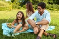 Family On Picnic. Happy Young Family Having Fun In Nature