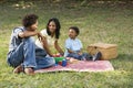 Family picnic in park.