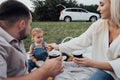 Family Picnic Time, Young Parents with Their Little Daughter Enjoying Weekend Outdoors, Road Trip on the SUV Car Royalty Free Stock Photo