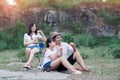 Family picnicking in the midst of nature with the cliff of background