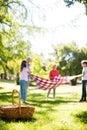 Family placing blanket in park