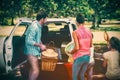Family placing picnic items in car trunk