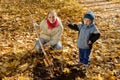 Family planting tree in autumn