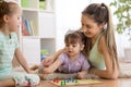 Family playing board game ludo at home on the floor