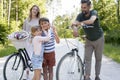 Family with playful children while bike ride in the woods