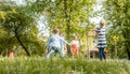 Family playing badminton on a meadow in summer Royalty Free Stock Photo