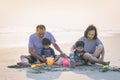 Happy healthy family Grandfather ,Grandmother and Nephew building sand castle on the beach smiling and carefree. Royalty Free Stock Photo