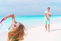 Little girl playing beach tennis on vacation with young father Royalty Free Stock Photo