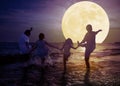 Family playing on beach and watching the moon.Celebrate Mid autumn festival concept