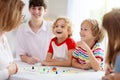Family playing board game. Kids play Royalty Free Stock Photo