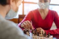 Family playing board games during curfew moving chess pieces Royalty Free Stock Photo