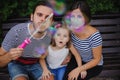 Family Playing With Bubbles In Garden Royalty Free Stock Photo