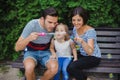 Family Playing With Bubbles In Garden Royalty Free Stock Photo