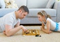 Family playing checkers. Royalty Free Stock Photo