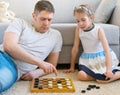 Family playing checkers. Royalty Free Stock Photo