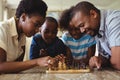 Family playing chess together at home in the living room Royalty Free Stock Photo