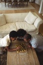 Family playing chess together at home in the living room Royalty Free Stock Photo