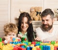 Family playing with colorful plastic blocks. Parents and kid Royalty Free Stock Photo