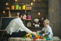 Family playing with constructor at home. Dad and child play with toy cars, bricks. Father and happy son play with Royalty Free Stock Photo