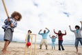 Family playing cricket on beach Royalty Free Stock Photo