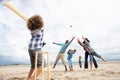 Family playing cricket on beach Royalty Free Stock Photo