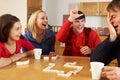 Family Playing Dominoes In Kitchen Royalty Free Stock Photo