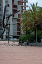 Family playing and feeding pidgeons next to sculpture in Barcelona