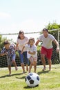 Family Playing Football In Garden Together Royalty Free Stock Photo