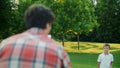 Family playing frisbee in field. Parents and children throwing frisbee disc Royalty Free Stock Photo