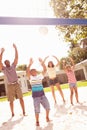 Family Playing Game Of Volleyball In Garden Royalty Free Stock Photo