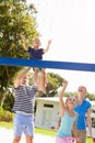 Family Playing Game Of Volleyball In Garden Royalty Free Stock Photo