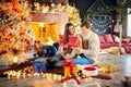 Family playing with gifts indoors on Christmas Day. Royalty Free Stock Photo