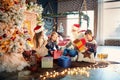 Family playing with gifts indoors on Christmas Day. Royalty Free Stock Photo