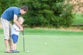 Family playing golf Royalty Free Stock Photo