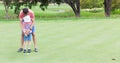 Family playing golf