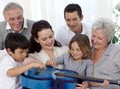 Family playing a guitar in living-room