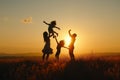 Family playing and jumping in sunset silhouette Royalty Free Stock Photo