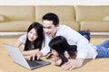 Family playing laptop on the floor at home Royalty Free Stock Photo