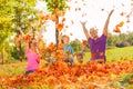 Family playing with leaves and throwing them Royalty Free Stock Photo